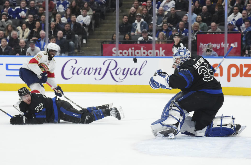 Toronto Maple Leafs goaltender Ilya Samsonov (35) makes a save on Florida Panthers forward Anthony Duclair (10) as Maple Leafs defenseman TJ Brodie (78) defends during the third period of an NHL hockey game in Toronto on Wednesday, March 29, 2023. (Nathan Denette/The Canadian Press via AP)