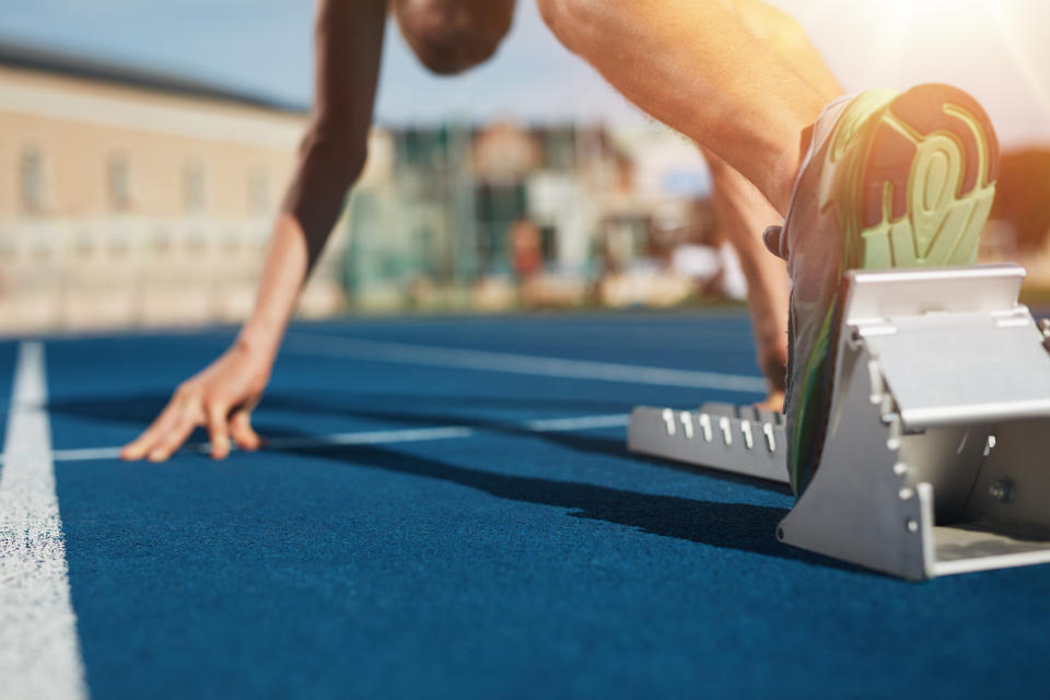 A person on a track in a starting block