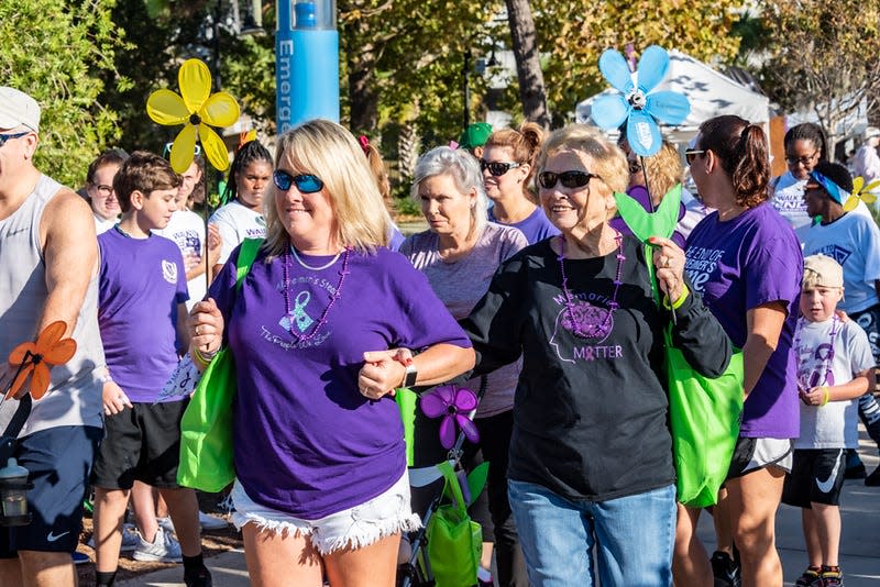 Walkers carry promise flowers to signify the reasons they walk in the Walk to End Alzheimer's. The 2023 Walk to End Alzheimer's will be held at 2 p.m. Nov. 5 at Cascades Park.