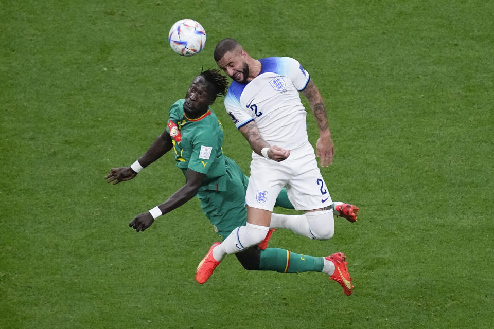 Senegal's Moussa Ndiaye, left, and England's Kyle Walker vie for the ball during the World Cup round of 16 soccer match between England and Senegal, at the Al Bayt Stadium in Al Khor, Qatar, Sunday, Dec. 4, 2022. (AP Photo/Darko Bandic)