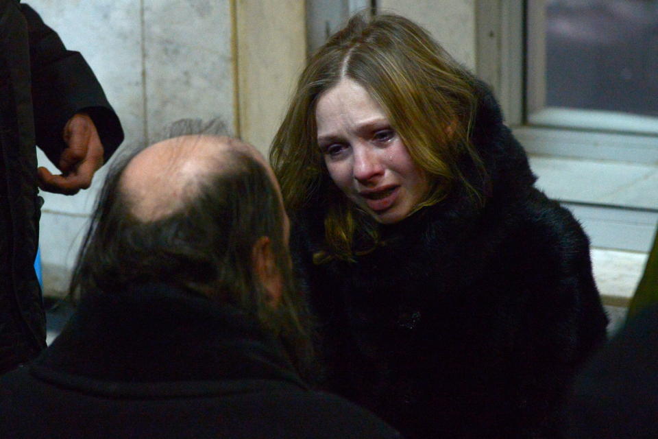 <p>A girl talks to a priest at a city airport. A Saratov Airlines Antonov An-148 plane with 71 people on board bound for the Ural city of Orsk crashed minutes after taking off from Domodedovo International Airport on Feb. 11, 2018. (Photo: TASS via Getty Images) </p>