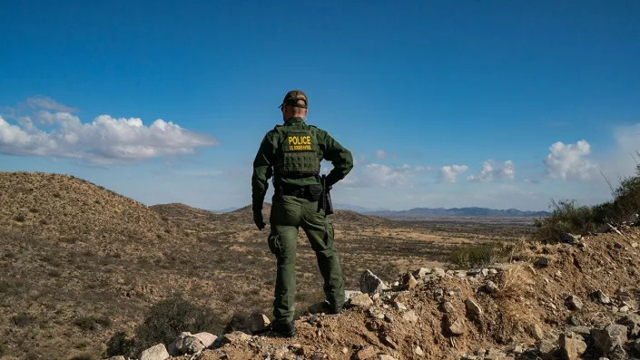 SASABE, ARIZONA - JANUARY 23: A U.S. Border Patrol agent stands on a cliff looking for migrants that crossed the border wall between the U.S. and Mexico near the city of Sasabe, Arizona, Sunday, January 23, 2022. <span class="copyright">Photo by Salwan Georges/The Washington Post via Getty Images</span>