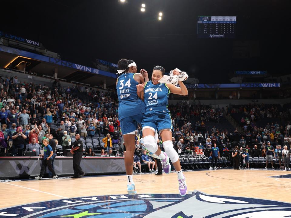 Napheesa Collier (right) and Sylvia Fowles celebrate a Minnesota Lynx victory.