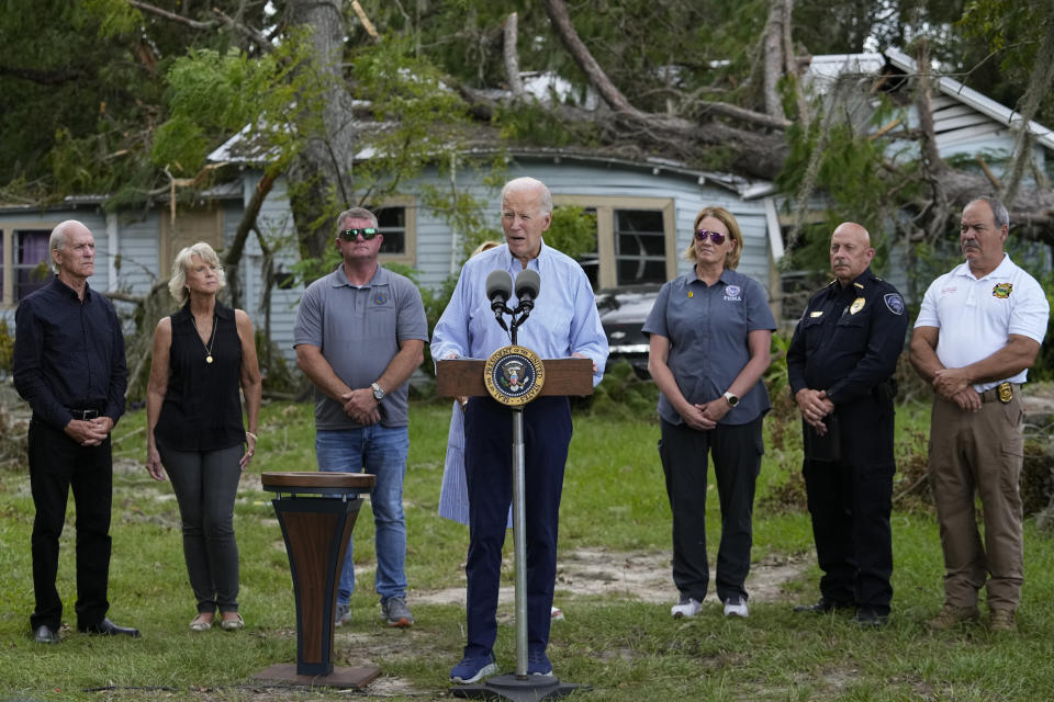 President Joe Biden speaks in front of a home damaged by fallen trees and debris following a survey of damage caused by Hurricane Idalia, Saturday, Sept. 2, 2023, in Live Oak, Fla. (AP Photo/Julio Cortez)