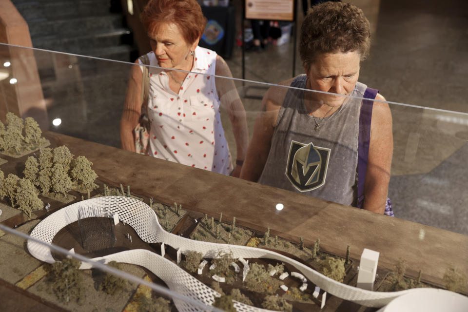 Marilyn Posster, left, and her daughter Pamela Posster, both of Las Vegas, check out a model by 1 October Memorial finalist Aaron Neubert Architects+studioSTIGSGAARD on display in the rotunda at the Clark County Government Center in Las Vegas, Monday, June 5, 2023. (K.M. Cannon/Las Vegas Review-Journal via AP)