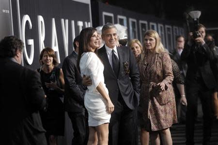Actors George Clooney and Sandra Bullock arrive for the film premiere of "Gravity" in New York October 1, 2013. REUTERS/Andrew Kelly/Files