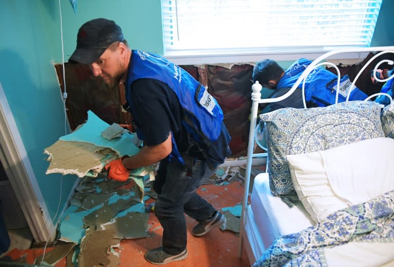 Ahmadiyya Muslim Youth Association members remove flood damaged drywall from a home in the Westbury neighborhood of southwest Houston, Texas