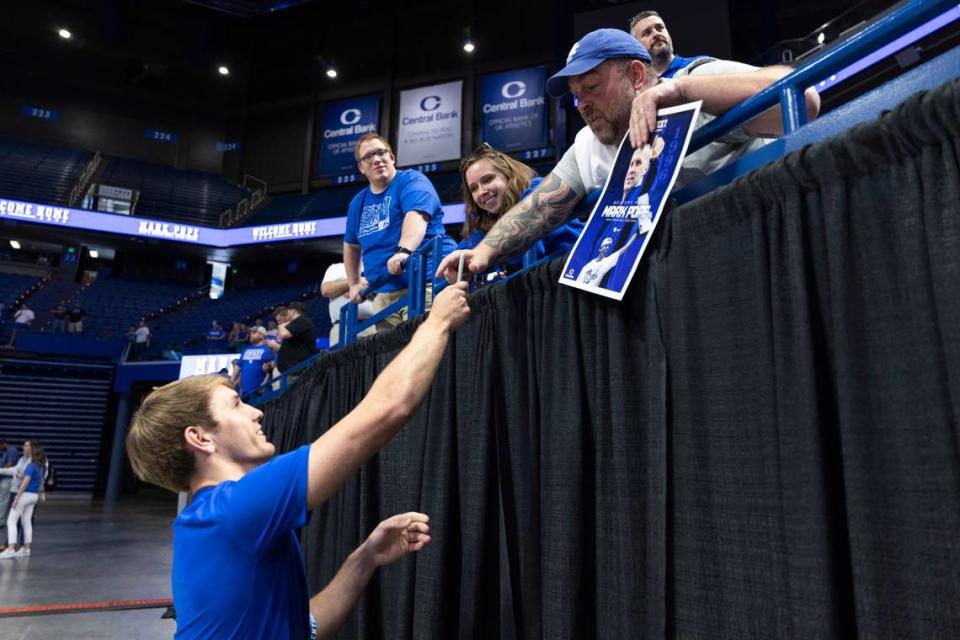 Kentucky signee Travis Perry signs an autograph for a fan during the introductory event for new UK basketball coach Mark Pope at Rupp Arena on Sunday.