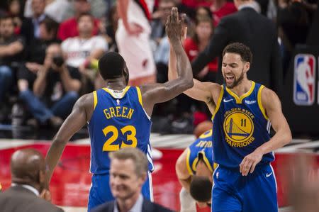 May 20, 2019; Portland, OR, USA; Golden State Warriors guard Klay Thompson (11) celebrates with forward Draymond Green (23) after Green scored a three-point basket in overtime against the Portland Trail Blazers in game four of the Western conference finals of the 2019 NBA Playoffs at Moda Center. The Warriors won 119-117 in overtime. Mandatory Credit: Troy Wayrynen-USA TODAY Sports