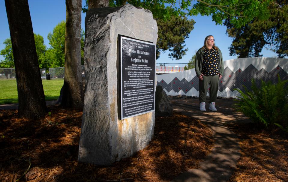 Grace Sanders, who was in the Thurston High School cafeteria the morning of the shooting in 1998 but escaped injury, visits the memorial near the school.