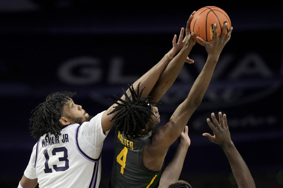 Baylor guard Ja'Kobe Walter (4) beats Kansas State forward Will McNair Jr. (13) to a rebound during the first half of an NCAA college basketball game Tuesday, Jan. 16, 2024, in Manhattan, Kan. (AP Photo/Charlie Riedel)