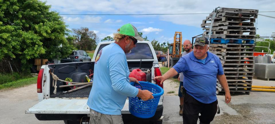 Crabbers' trucks trickle through Island Crab Co. throughout late afternoon Oct. 15 with season's first legal stone crab catch.