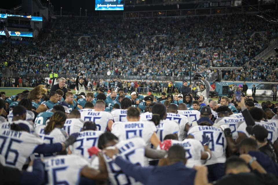 Tennessee Titans and Jacksonville Jaguars players meet on the field to say a prayer. (AP Photo/Phelan M. Ebenhack)