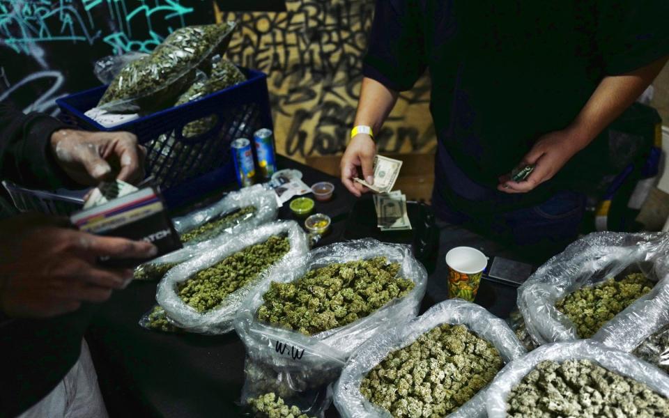 A marijuana customer at a cannabis marketplace in Los Angeles - Richard Vogel/AP