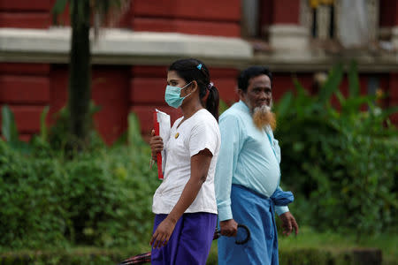 A woman wears a mask on his face to protect herself from H1N1 in Yangon, MyanmarJuly 24, 2017. REUTERS/Soe Zeya Tun