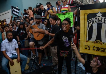 Members of theatre group Papel Machete perform during a protest calling for the resignation of Governor Ricardo Rossello in front of La Fortaleza in San Juan, Puerto Rico