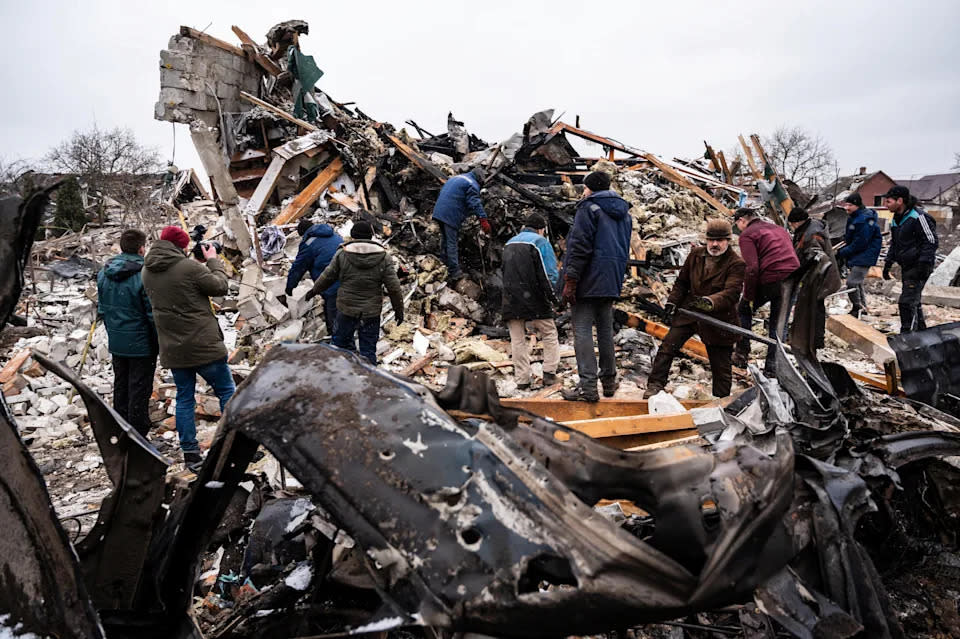 Local residents work among remains of a residential building destroyed by shelling in Zhytomyr on March 2. Source: Reuters
