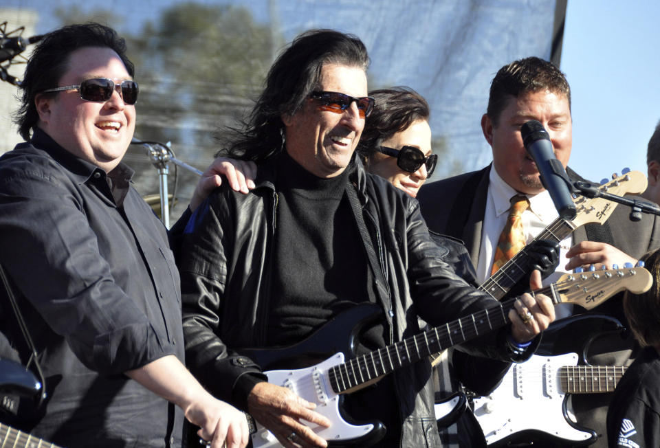 Chuck Brennan, left, majority owner of Dollar Loan Center, and heavy metal icon Alice Cooper, center, kick off a 6,000-square-foot rock ëní roll academy will be open exclusively to the area's 250 Boys & Girls Clubs members, Wednesday, Oct. 10, 2012, in Sioux Falls, S.D. (AP Photo/Dirk Lammers)