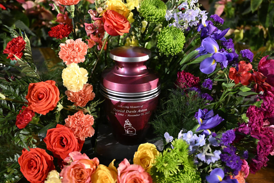 A cremation urn with Daniel Aston's ashes is surrounded by flowers during a memorial service held at Shove Memorial Chapel on the Colorado College's campus on Dec. 7, 2022, in Colorado Springs, Colo. Aston, a 28-year-old transgender man, was one of five people killed in the Club Q mass shooting on Nov. 19. (RJ Sangosti/The Denver Post via AP, Pool)