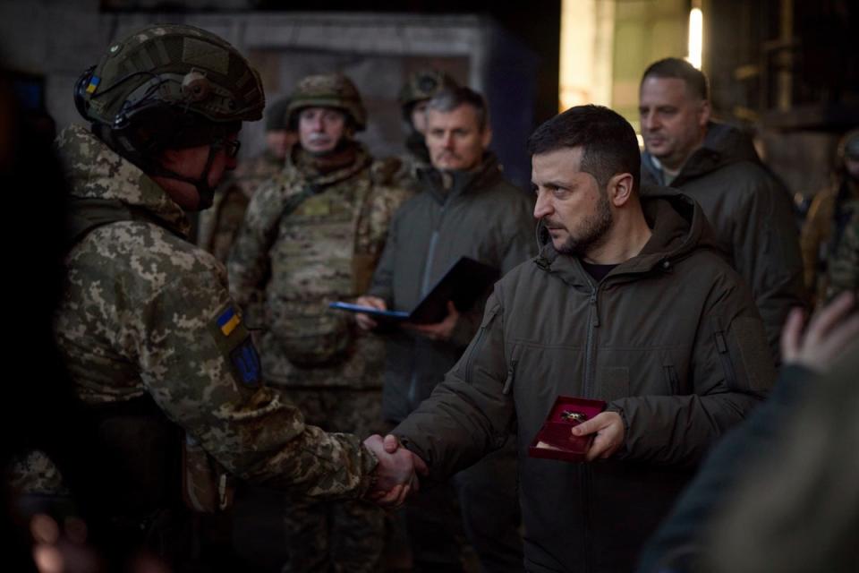 Ukrainian president Volodymyr Zelensky, right, awards a serviceman at the site of the heaviest battles with the Russian invaders in Bakhmut (Ukrainian Presidential Press Office)