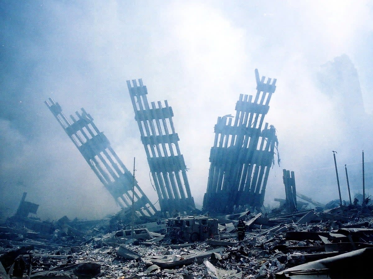 Rubble smolders at the wreckage of the World Trade Center on 11 September, 2001 (AFP via Getty Images)