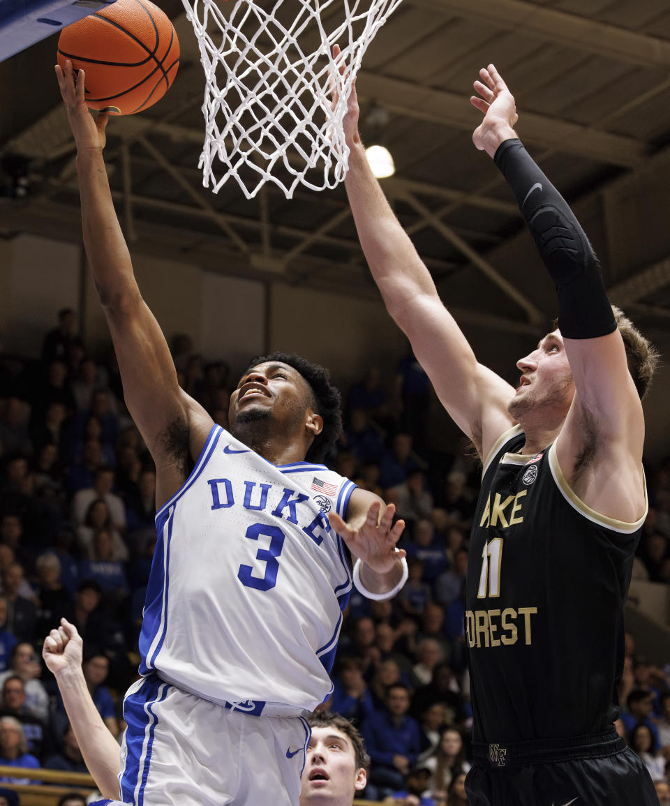 Duke's Jeremy Roach (3) attempts a layup ahead of Wake Forest's Andrew Carr (11) during the second half of an NCAA college basketball game in Durham, N.C., Monday, Feb. 12, 2024. (AP Photo/Ben McKeown)