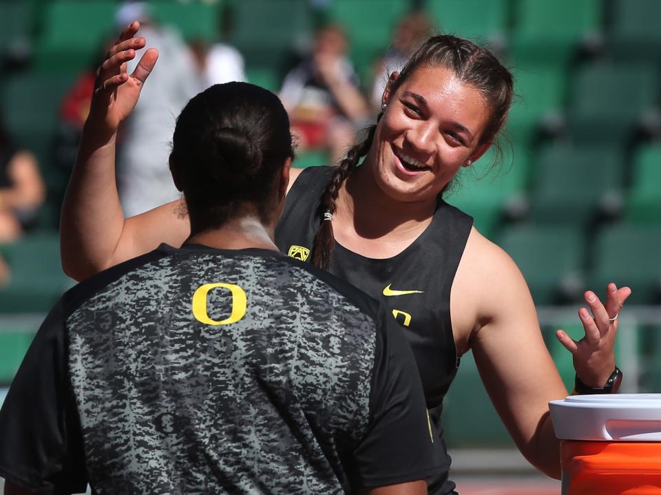 Oregon throwers Mine De Klerk, right, and Jaida Ross, left, celebrate a one, two finish in the Women Shot Put Throw at the Hayward Premiere at Hayward Field Saturday April 2, 2022.