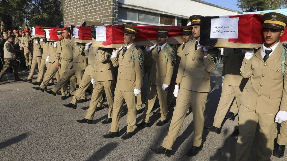 Syrian student officers carry the coffins of their comrades who were killed on Thursday in a drone attack that hit a military graduation ceremony, during a mass funeral procession in Homs, Syria, Friday, Oct. 6, 2023. Family members of some of the victims of deadly drone attacks on a crowded military graduation that killed scores gathered outside a military hospital in this central city Friday to collect the bodies of their loved ones who lost their lives in one of Syria's deadliest single attacks in years. (AP Photo/Abdelrahman Shaheen) - Abdelrahman Shaheen/AP