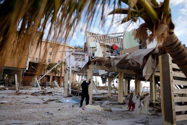 PHOTO: A member of Florida Task Force 8 urban search and rescue tags a condominium building that has been checked and found clear of people, in Fort Myers Beach, Fla., Oct. 5, 2022, one week after the passage of Hurricane Ian. (Rebecca Blackwell/AP)