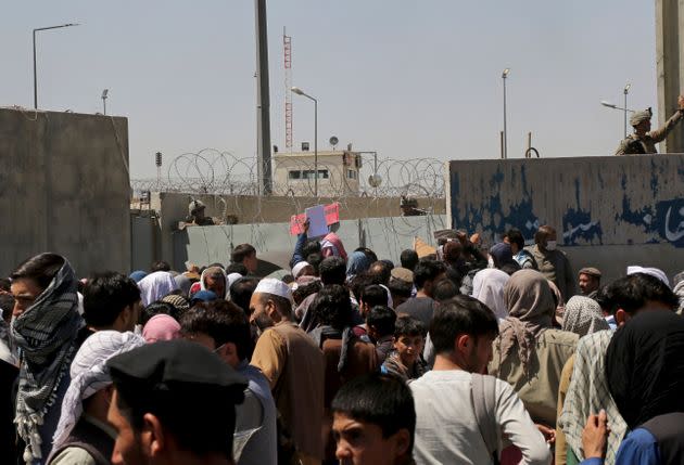 US soldiers stand inside the airport wall as hundreds of people gather near an evacuation control checkpoint on the perimeter of the Hamid Karzai International Airport, in Kabul, Afghanistan, Thursday, Aug. 26, 2021 (Photo: via Associated Press)