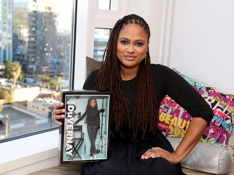 Ava DuVernay holds a Barbie version of herself