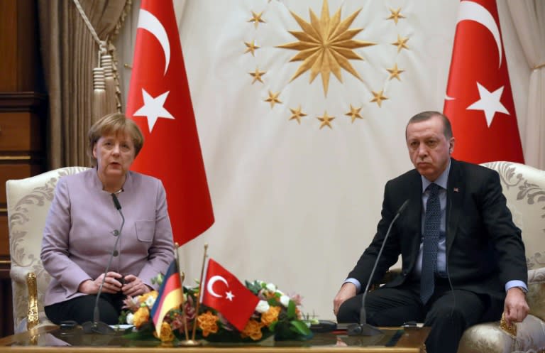 Turkish President Recep Tayyip Erdogan (R) listens on as German Chancellor Angela Merkel speaks during their meeting at the Presidential Palace in Ankara on February 2, 2017