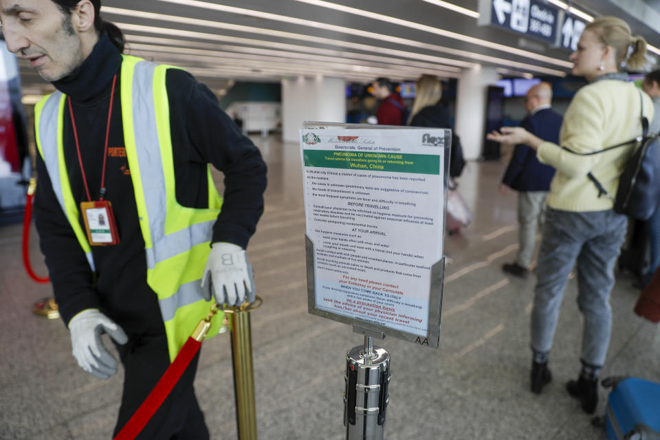 A notice explaining precautions to be taken by people traveling to Wuhan, China, is seen at a terminal of Rome's International Fiumicino airport, Tuesday, Jan. 21, 2020. Heightened precautions are being taken worldwide as a new strain of coronavirus has been infecting hundreds of people across the central Chinese metropolis. (AP Photo/Gregorio Borgia)