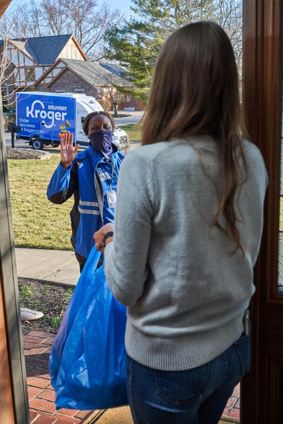 Kroger delivery driver waves to customer