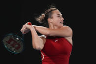 Aryna Sabalenka of Belarus plays a backhand return to Germany's Ella Seidel during their first round match at the Australian Open tennis championships at Melbourne Park, Melbourne, Australia, Monday, Jan. 15, 2024. (AP Photo/Andy Wong)