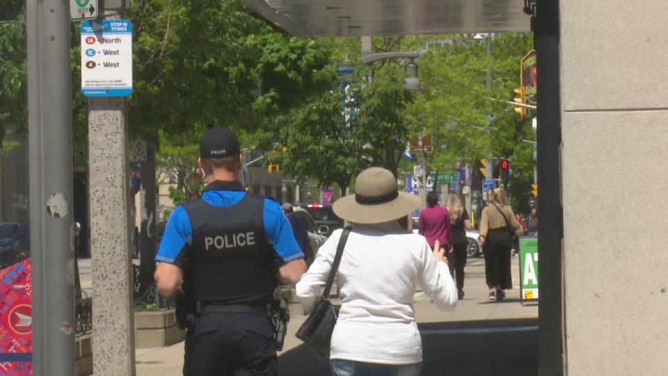 A downtown Windsor police officer accompanies a citizen.
