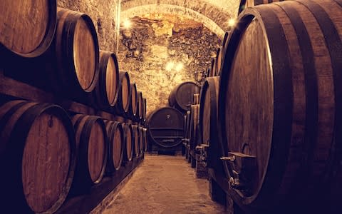 Barrells are stacked up in one of Porto's many subterranean wine cellars - Credit: AP/FOTOLIA