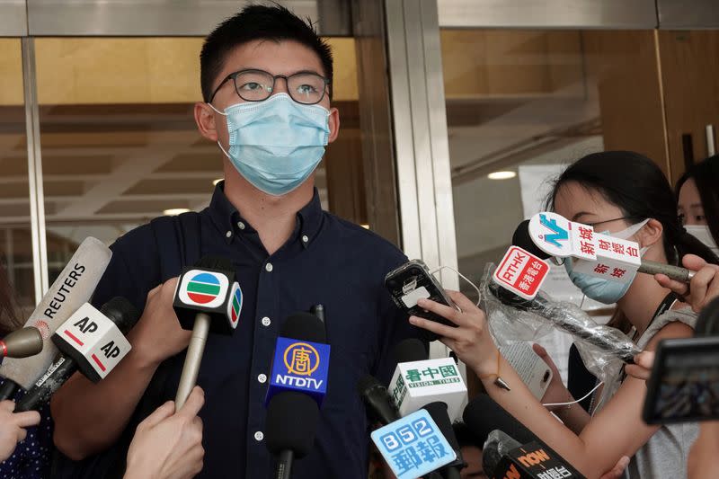 Pro-democracy activist Joshua Wong speaks to the media at the High Court in Hong Kong