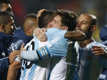 Argentina's Lionel Messi (R) and Argentina's Tevez hug after defeating Colombia in penalties following regulation play in their Copa America 2015 quarter-finals soccer match at Estadio Sausalito in Vina del Mar, Chile, June 26, 2015. REUTERS/Marcos Brindicci