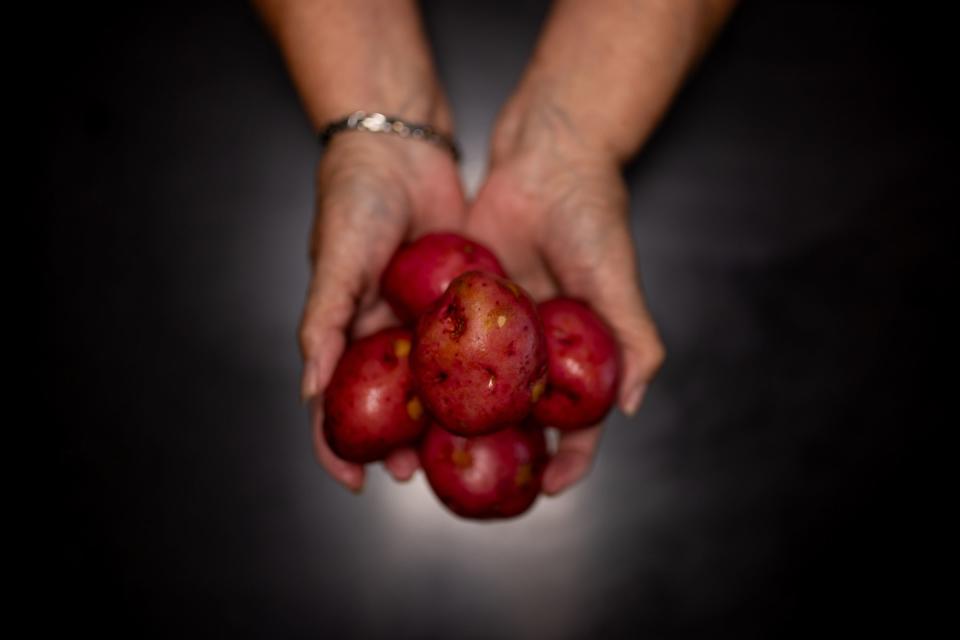 Norma Thornton holds a handful of red potatoes she is using to cook a meal to give out to homeless people at her home in Bullhead City, Ariz., on Tuesday, Oct. 24, 2023. | Spenser Heaps, Deseret News