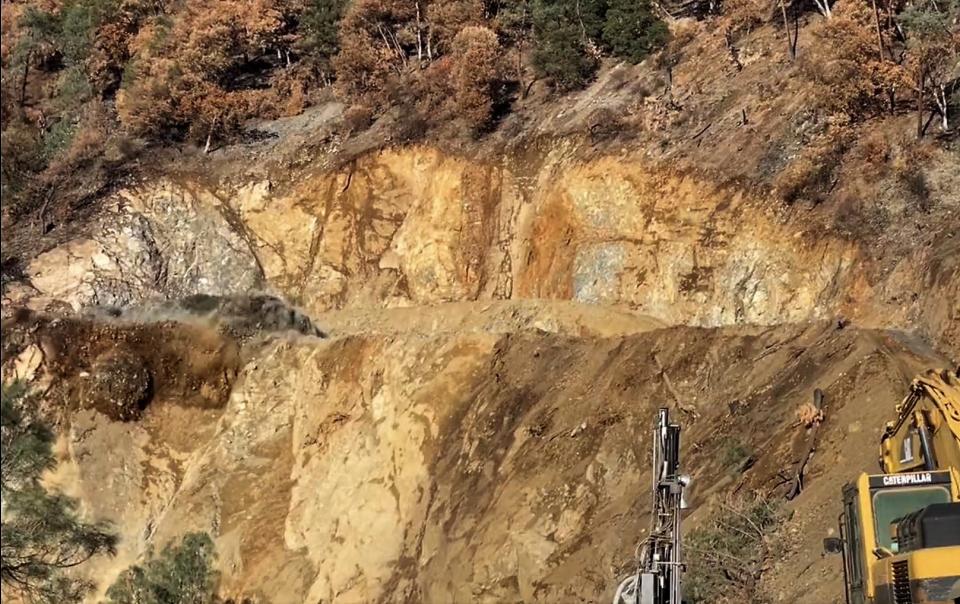 Blasting (at left) took place in mid-November along Highway 299 in the area of the Monument Slide in Trinity County, according to District 2 of the state Department of Transportation. Repairs are being made to the highway in the area from Cedar Flat to east of Big Bar due to damage from the Monument Fire and rockslides.