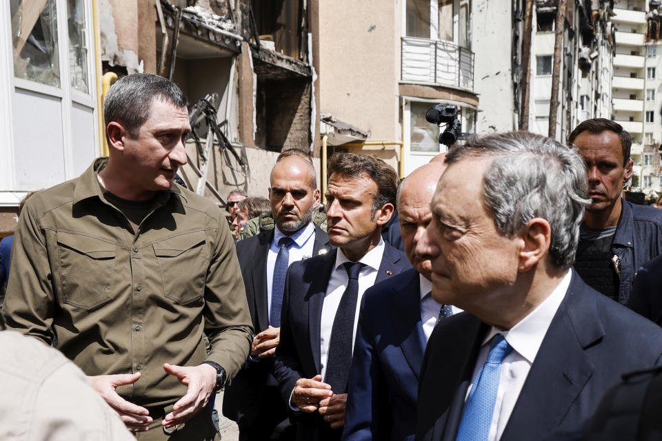 French President Emmanuel Macron, center, German Chancellor Olaf Scholz, partially obscured second right, and Italian Prime Minister Mario Draghi, right, visit Irpin Thursday, June 16, 2022. The leaders of France, Germany, Italy and Romania arrived in Kyiv on Thursday in a show of collective European support for the Ukrainian people as they resist Russia's invasion, marking the highest-profile visit to Ukraine's capital since Russia invaded its neighbor. (Ludovic Marin, Pool via AP)