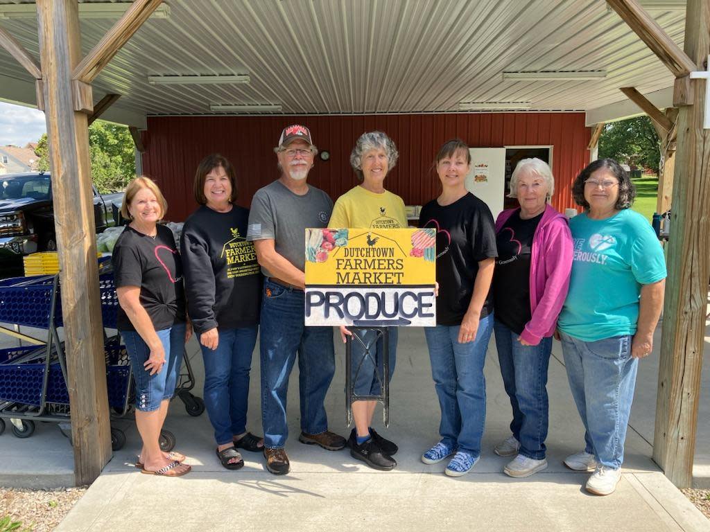 Marlene Siefert, left, Janell Benner, Steve Kirgis, Debbie Mohr, Brenda Breyley, Irene Springer and Betty Shell set up at the Dutchtown Farmers Market in New Washington in 2023. The market runs May-December. (PROVIDED BY JANELL BENNER)