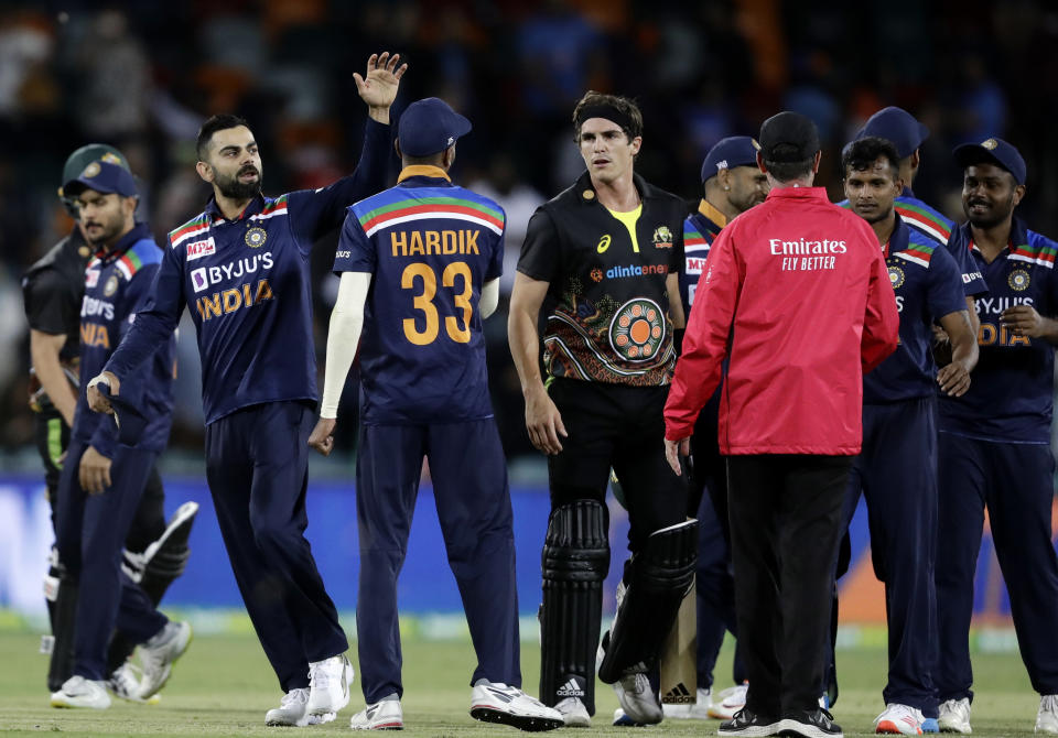 India's Virat Kohli, second left, celebrates with teammates after their T20 international cricket match against Australia at Manuka Oval, in Canberra, Australia, Friday, Dec 4, 2020. India won the match by 11 runs. (AP Photo/Mark Baker)