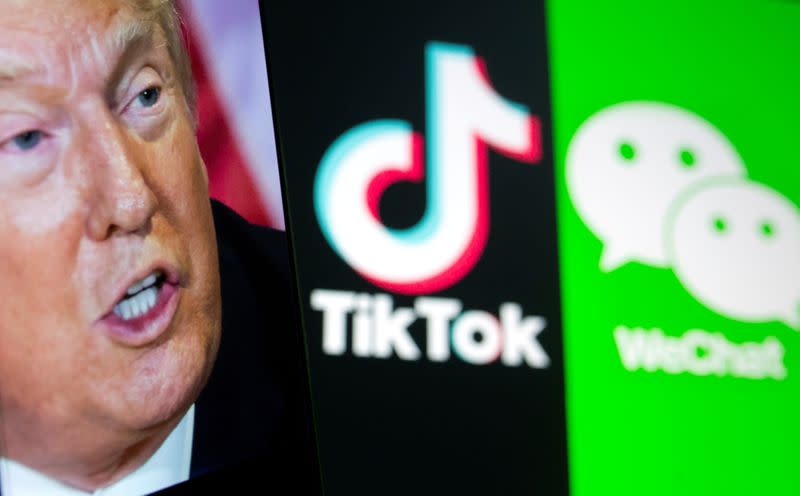 FILE PHOTO: A picture of U.S. President Donald Trump is seen on a smartphone in front of displayed Tik Tok and WeChat logos in this illustration