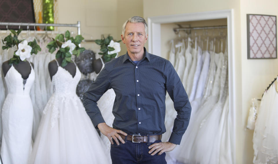 David Gaffke, owner of the bridal salon Complete Bridal, poses in his shop in East Dundee, Illinois, on Feb. 28, 2020. He is heavily reliant on China for manufacturing. “It's frustrating when it comes to having to tell a bride that we're not able to fulfill your needs,” he said. “This is the most important dress they're going to wear.” (AP Photo/Teresa Crawford)