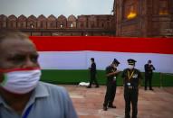 Security personnel wearing face masks wait for the start of the Independence Day ceremony on the ramparts of the landmark Red fort monument in New Delhi, India, Saturday, Aug. 15, 2020. India’s coronavirus death toll overtook Britain's to become the fourth-highest in the world with another single-day record increase in cases Friday. (AP Photo/Manish Swarup)