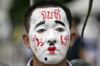 A pro-democracy demonstrator with a face paint that reads 'End it with our generation' during a protest at Thammasat University in Pathum Thani, north of Bangkok, Thailand, Monday, Aug, 10, 2020. Protesters warned that they'll step up pressure on the government if it failed to meet their demands, which include dissolving the parliament, holding new elections and changing the constitution. (AP Photo/Sakchai Lalit)