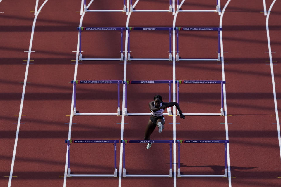 Anne Zagre, of Belgium, runs alone in a heat in the women's 100-meter hurdles at the World Athletics Championships on Saturday, July 23, 2022, in Eugene, Ore. Zagre in lane six got hampered during the race at the 10th hurdle by Nia Ali, of the USA in lane five. Ali of the USA knocked a hurdle over and got in lane six, affecting Zagre. (AP Photo/Gregory Bull)