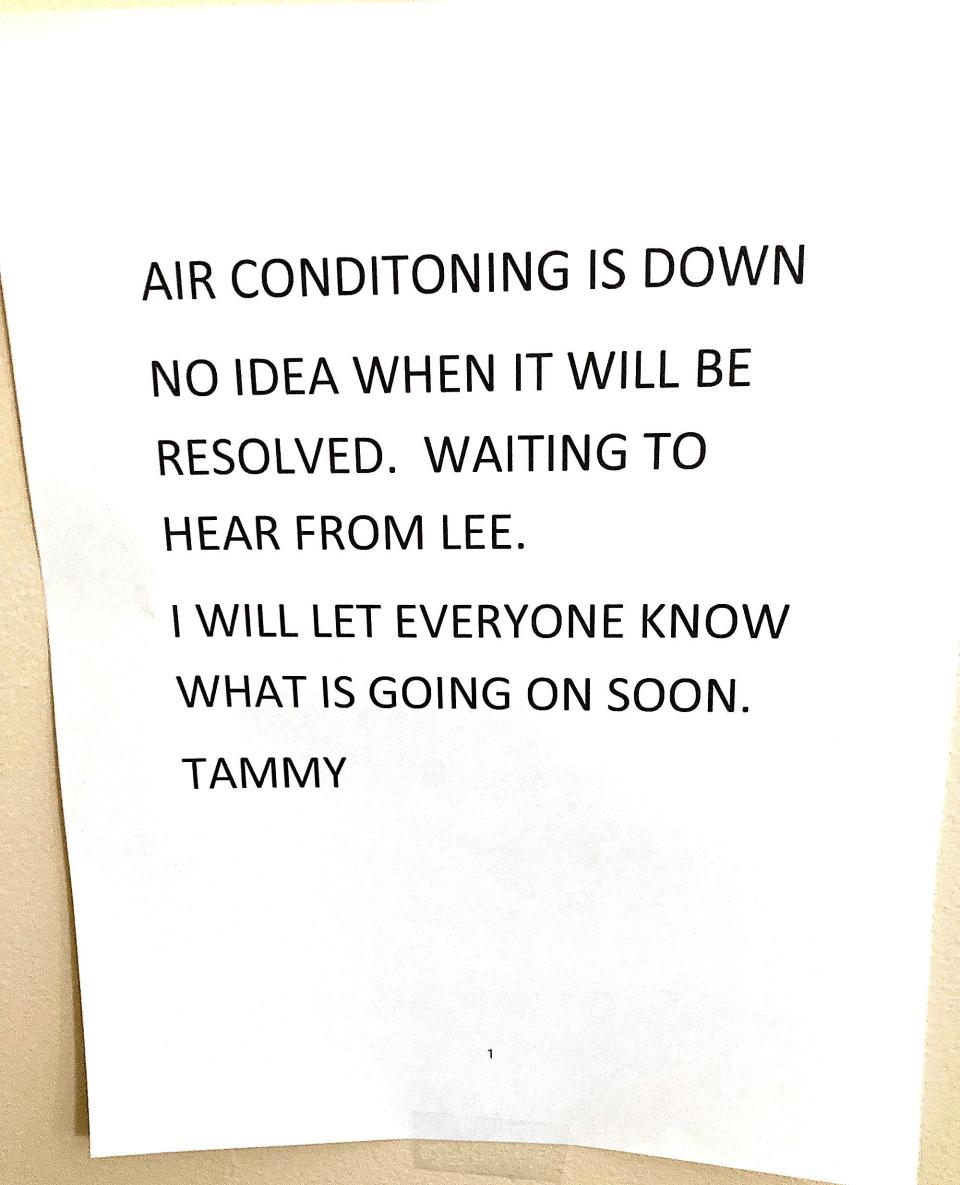 Signs next to a bulletin board on one of the floors of the Essex House state that the central air conditioning is not working.